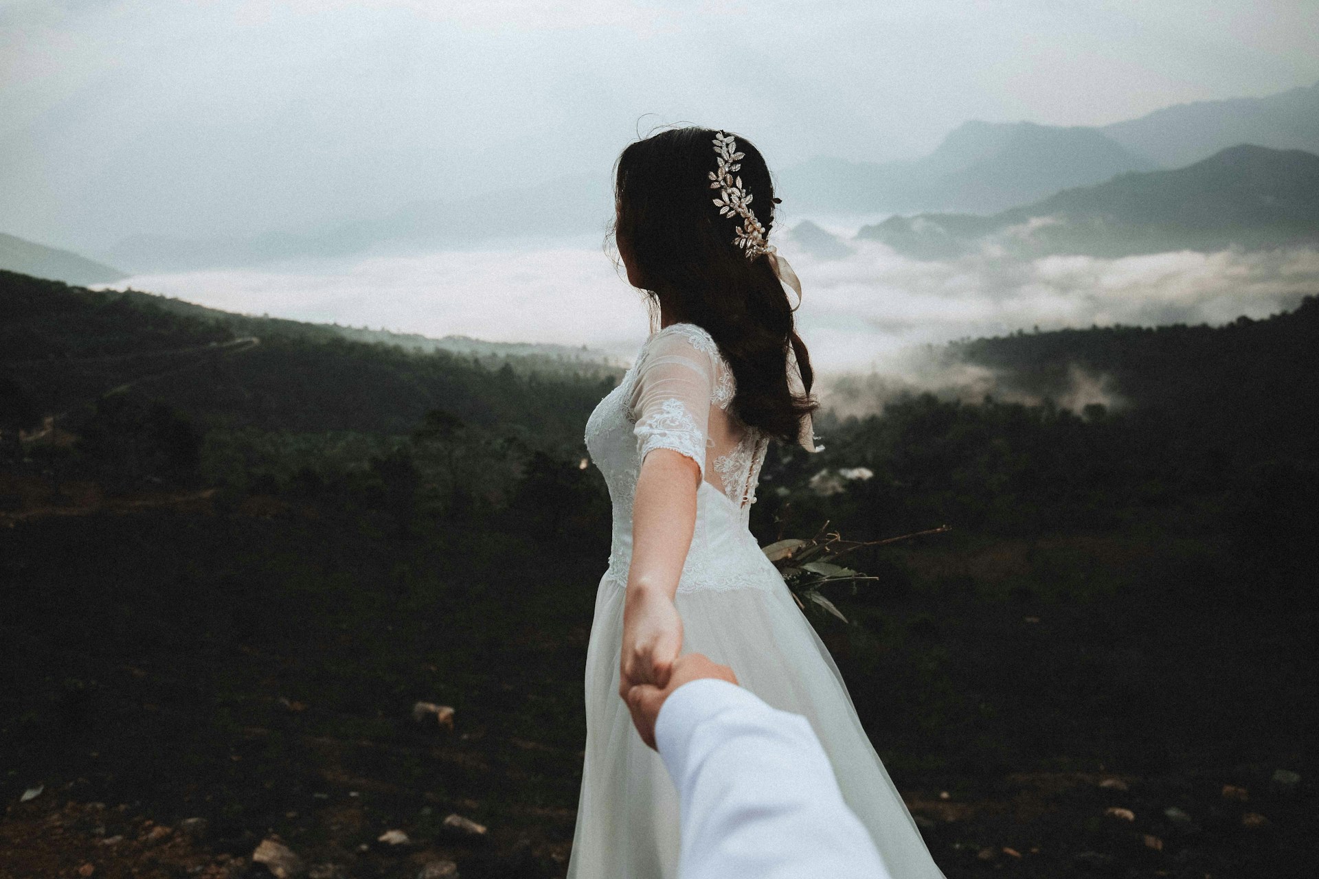 Bride turned away from the camera, holding someone’s hand